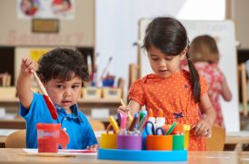 Preschool children painting at New Horizon Academy preschool and daycare center